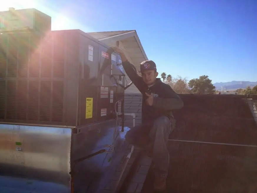 HVAC technician performing HVAC Inspection on a rooftop unit in Lynnwood
